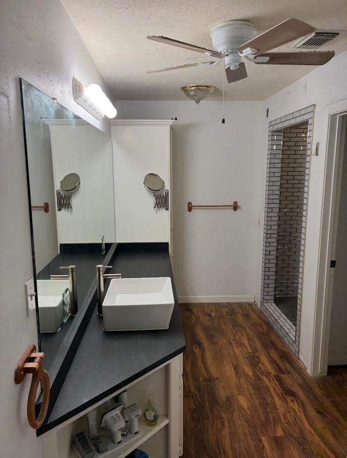 SHOWER WAS DOUBLED IN SIZE, COUNTER, FLOOR, MIRROR & LIGHT FIXTURE ALL NEW!